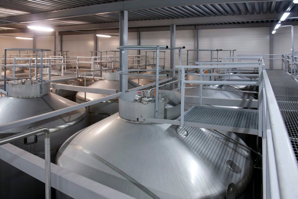 Interior of brewery, large steel storage tanks for brewing beer.