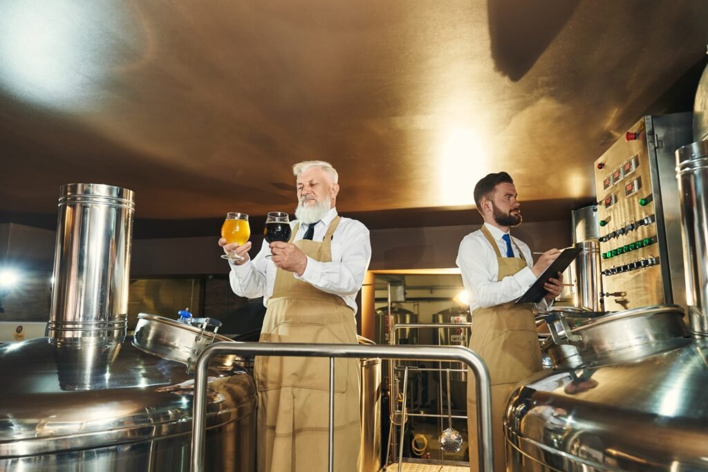 Two men standing in beer manufacturing factory